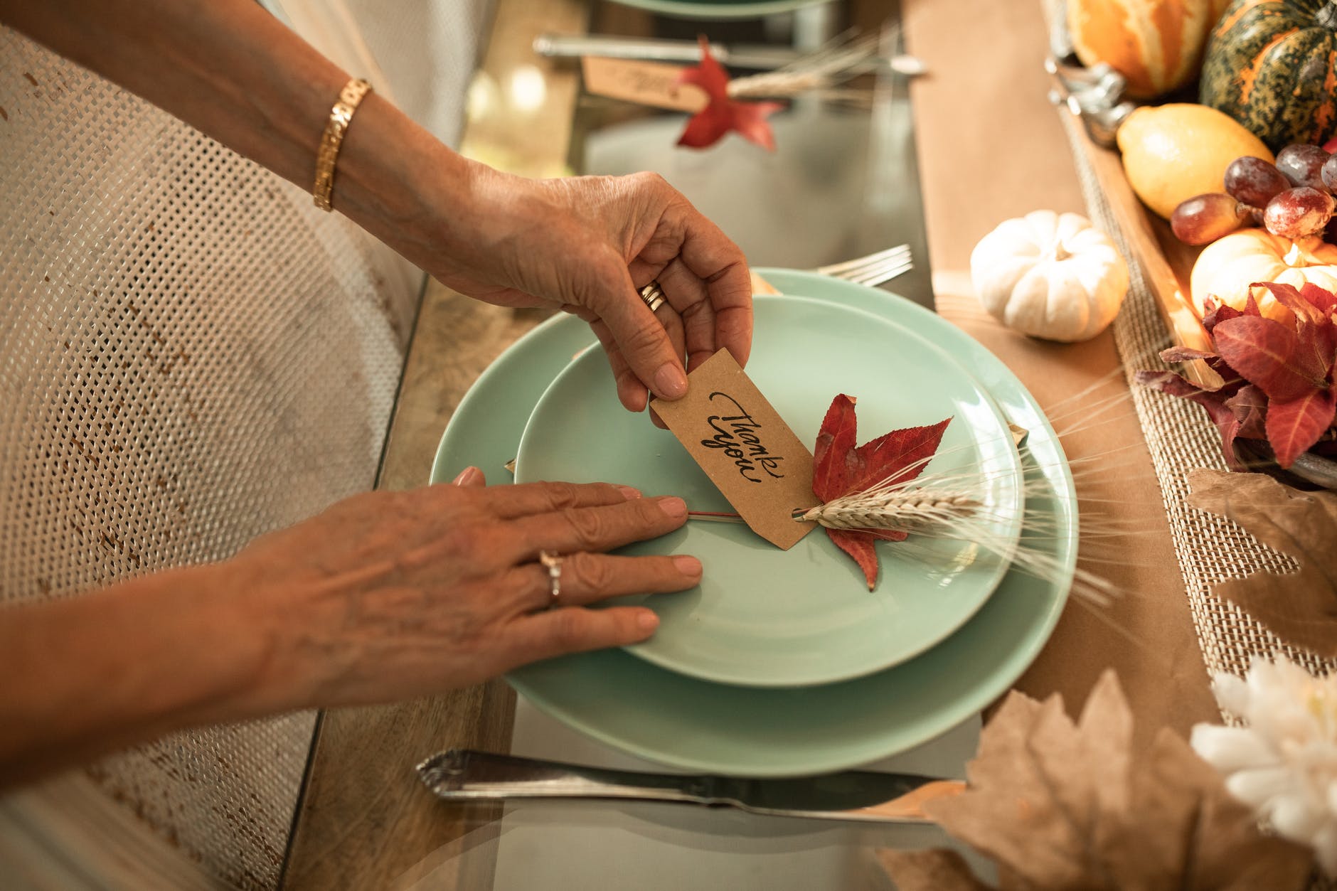 person holding brown wooden chopping board