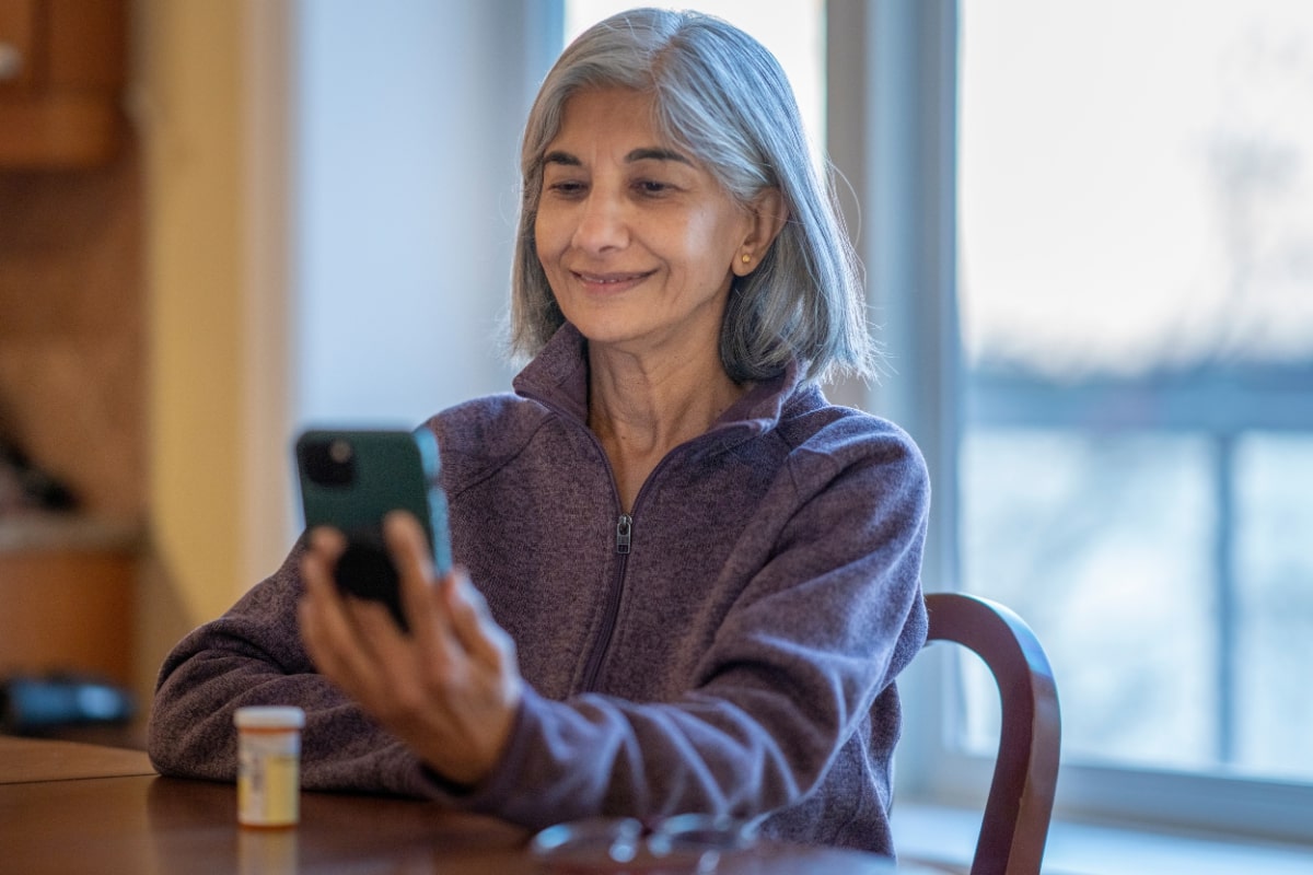 An old woman taking online mental health medication with insurance